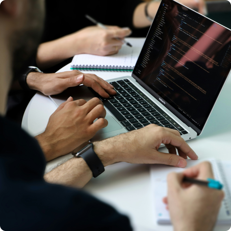 Recruiters reviewing candidate profiles together on a laptop